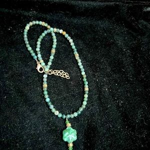 Green bead with carved stone pendant